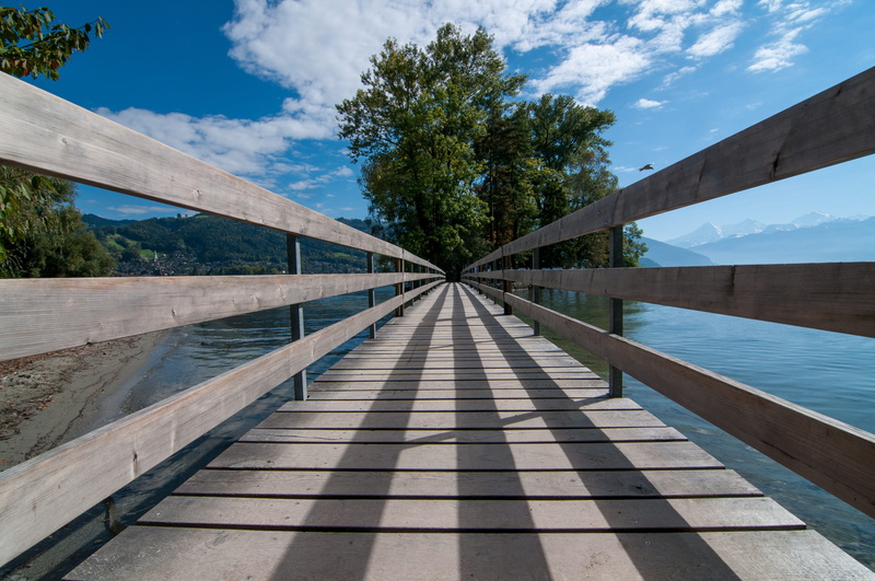 sunlight, lake, the way forward, footpath, no people, footbridge, outdoors, way, thunersee, day, shadow, connection, sky, cloud - sky, water, direction