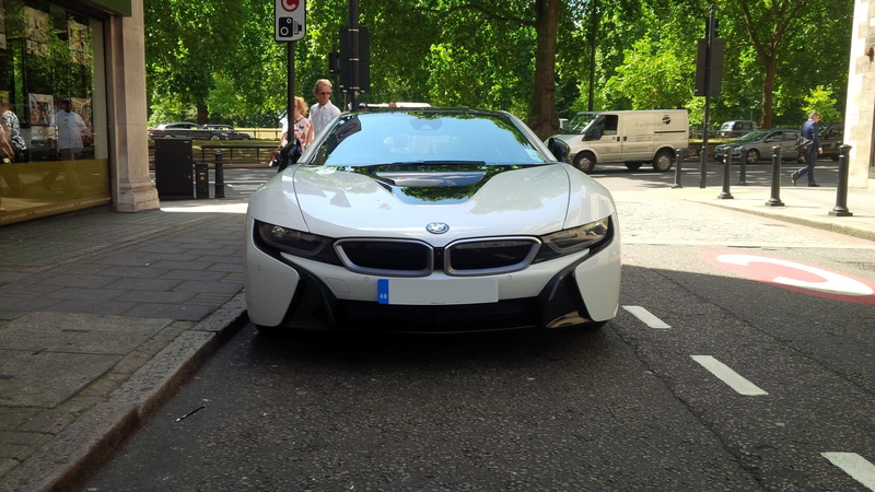 plant, reflection, mode of transportation, luxury, sunlight, city, human limb, motor vehicle, outdoors, day, incidental people, sports car, travel, stationary