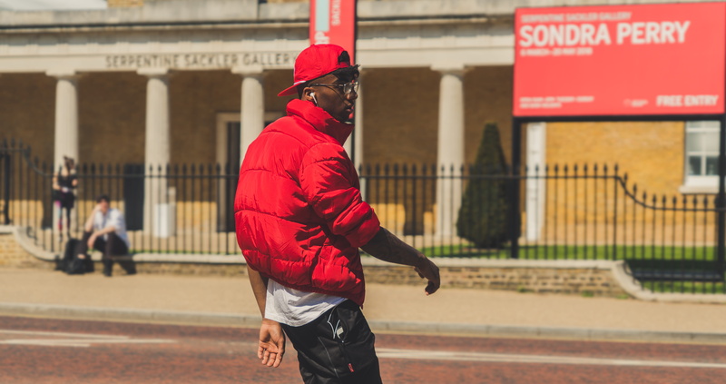 three quarter length, skater, red, outdoors, one person, foreground, built structure, center, casual clothing, art, building exterior, architecture, skating