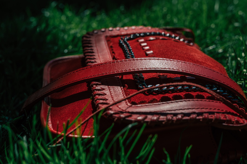 color, plant, sport, personal accessory, red, field, black, pattern, close-up, selective focus, land, outdoors, purse, metallic, still life, textile, park