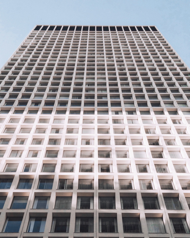 minimal, building exterior, low angle view, city, no people, twilight, highrise, hotel, sky, rise, window, geometric shape, skyscraper, light, looking up
