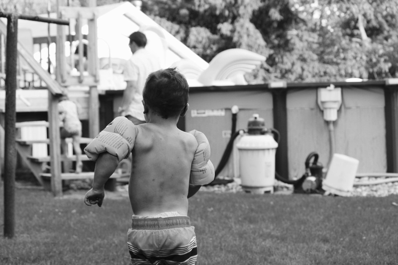 nephew, son, leisure activity, three quarter length, blog, kid, childhood, water, shorts, rear view, one person, pool, lifestyles, innocence, floats, shirtless