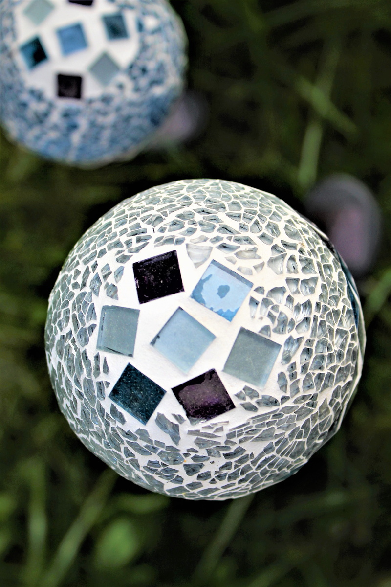 focus on foreground, lamp, plump, round, no people, glass, blue, pattern, day, shape, outdoors, soccer ball, background, ball, still life, sports equipment