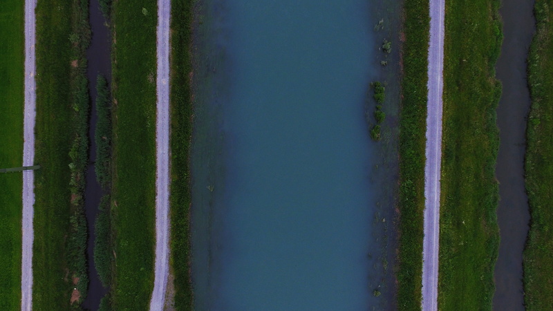 tranquil scene, green color, birds eye, 4K, aerial view, grass, road, growth, blue, field, blue water, straight, tow path, agriculture, tranquility, plant