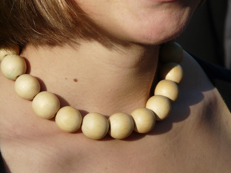 wood jewelry, jewelry, midsection, Necklace, woman, neck, human lips, human skin, child, wood beads, front view, 2K, close-up, skin, leisure activity