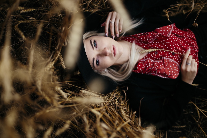 portrait, hat, women with hats, 2K, lying on back, top view, women outdoors, black coat, long hair, blonde, wheat, looking at viewer, model, Yana Lypkan