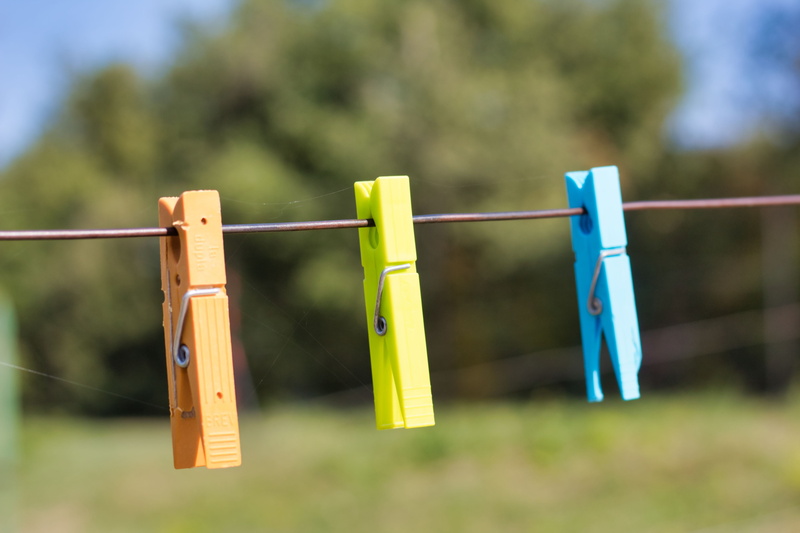 drying, laundry, outdoors, out, group of objects, security, close-up, clamp, clothesline, hanging, hang, clothes, yellow, clothing, washing, color, clothespins