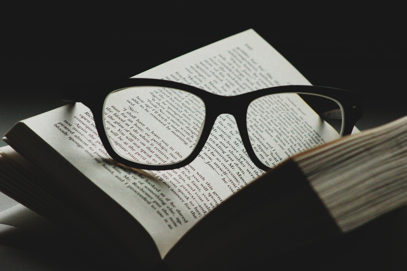 reading glasses, glasses, eyeglasses, eyewear, black background, still life, glass, newspaper, frames, selective focus, word, open, page, read, indoors