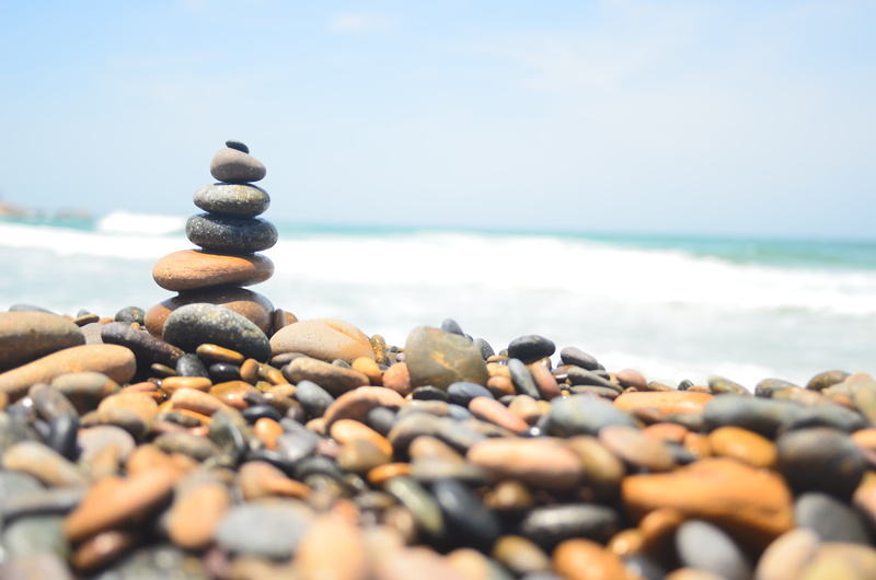 the ocean, gravel, horizon over water, waves, land, scenics - nature, solid, stone, tranquil scene, large group of objects, pebble, water, rock - object