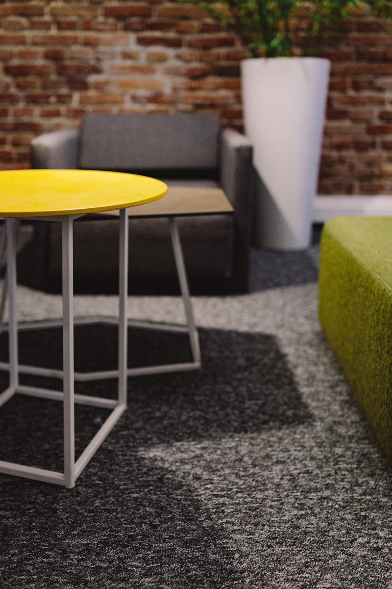decor, seat, empty, table, coffee table, no People, shadow, photos, absence, focus on foreground, yellow, Abstract, luxury, sofa, rug, chair, brick, shapes