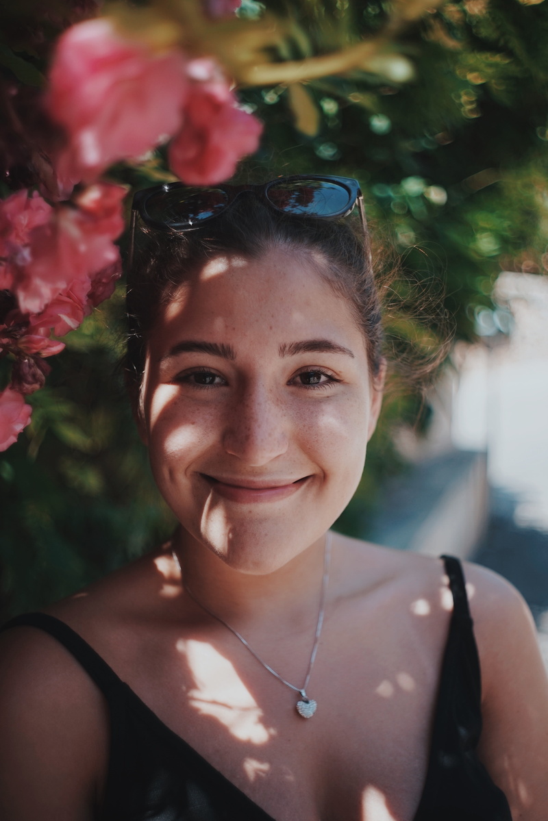 child, looking at camera, vacation, tree, spaghetti, women, emotion, black, girl, headshot, childhood, flower, hairstyle, females, top, human face, bush
