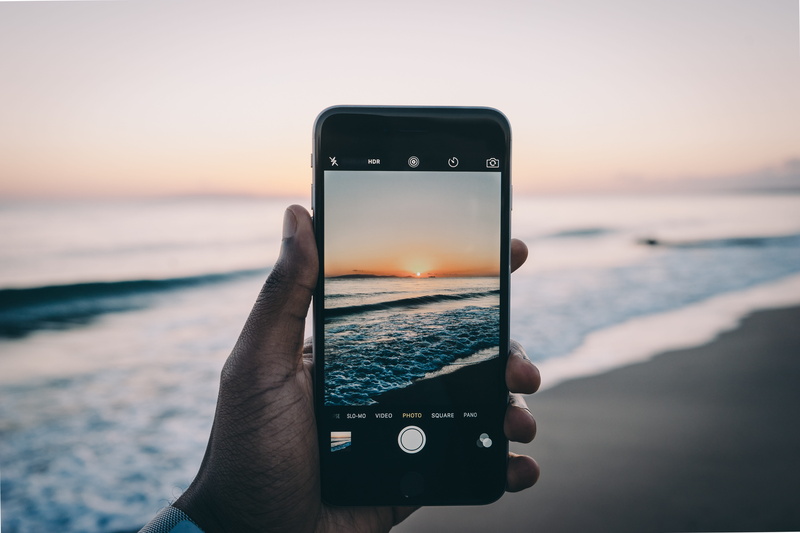 smart phone, wireless technology, samsung, technology, holding, human body part, one person, android, outdoors, activity, ios, communication, water, sunset