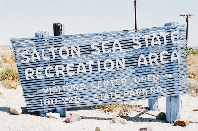 beach, recreation, built structure, day, non-western script, communication, wood - material, close-up, rectangular, side, city, information, painted, sea