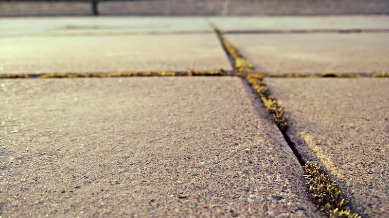 no people, road, footpath, concrete, textured, absence, nature, sign, asphalt, close-up, city, day, transportation, high angle view, grass, outdoors, surface level