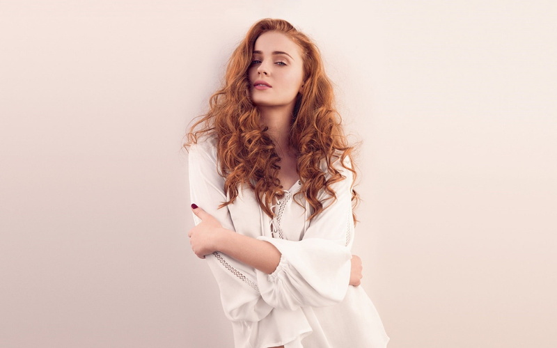 front view, long hair, indoors, hairstyle, human face, Sophie Turner, beauty, one person, contemplation, looking at camera, innocence, portrait, curly hair