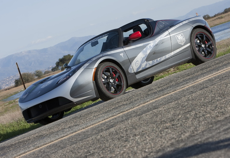 plant, motor vehicle, road, transportation, motion, tag, land vehicle, outdoors, heuer, mountain, day, speed, car, travel, no people, nature, tesla, mode of transportation