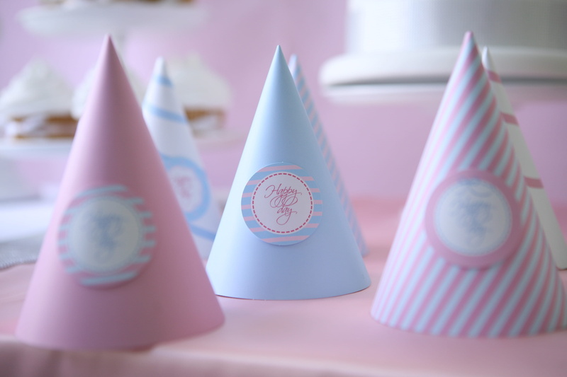 western script, party hats, pastel colored, variation, pink color, party, hats, cone, focus on foreground, art and craft, creativity, craft, blue, wooden table