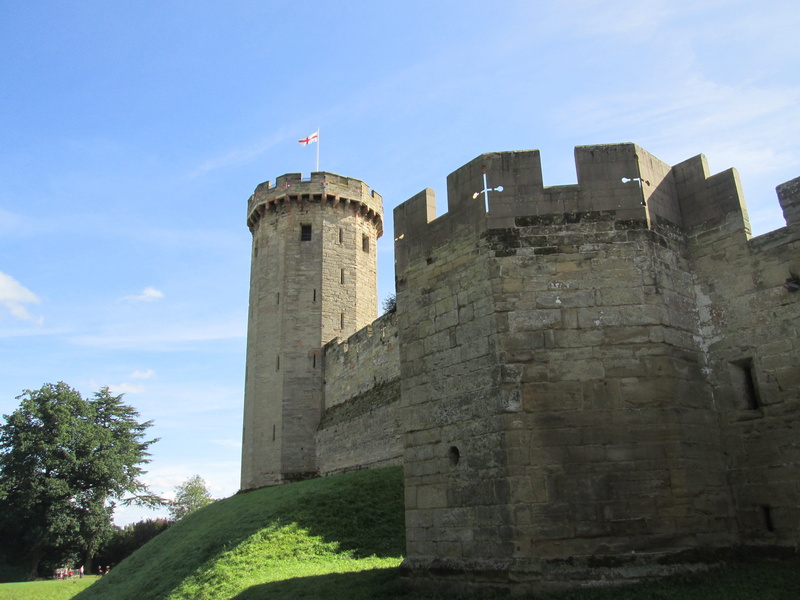 cloud - sky, day, tower, warwick castle, outdoors, castle, flag, england, fort, sky, history, architecture, travel destinations, building exterior, stone wall