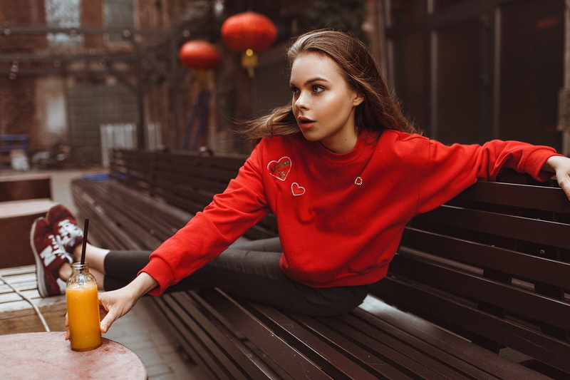 sitting, portrait, looking into the distance, sweatshirts, model, red, young adult, refreshment, 1080P, table, bench, lifestyles, outdoors, hairstyle