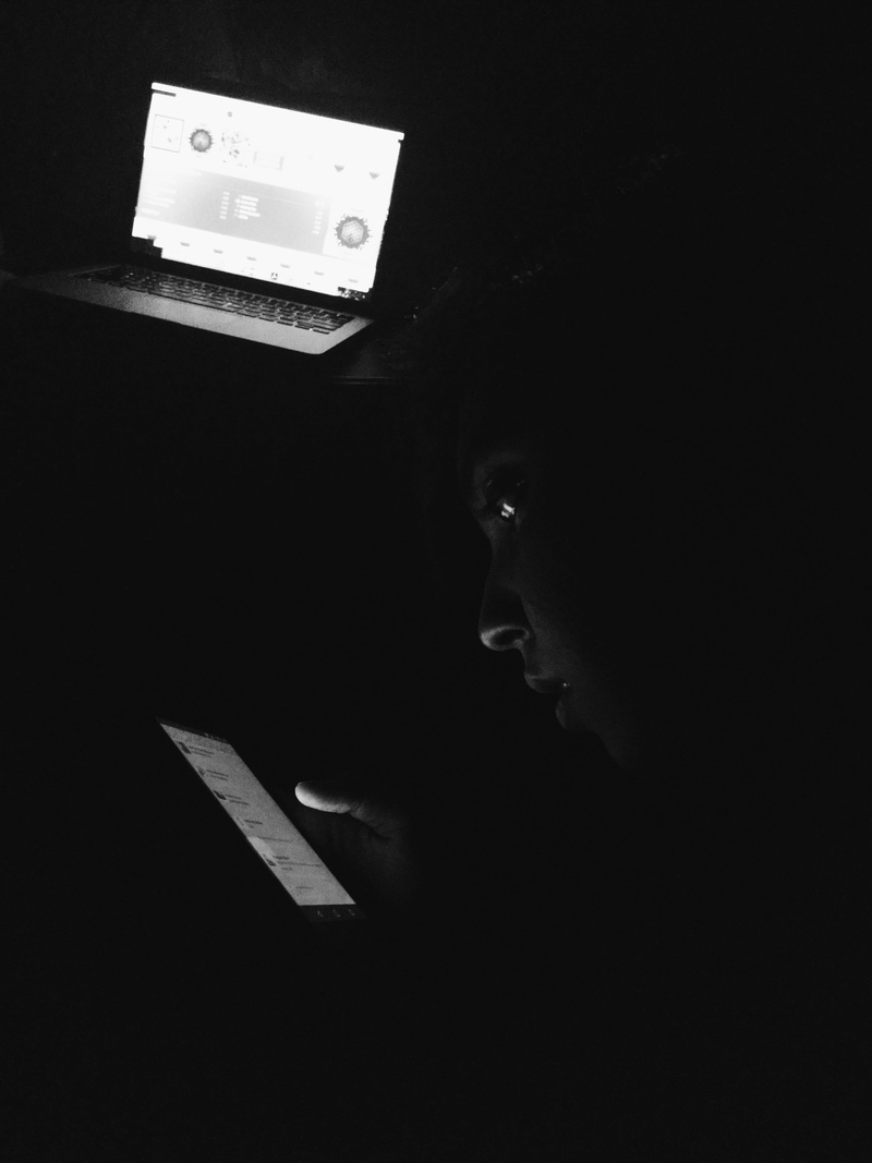 headshot, domestic room, indoors, communication, phone light, black and white, night, low light, 5K, text, males, men, dark, side view, black background