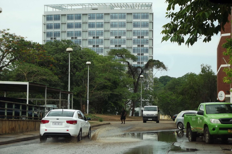 growth, real people, building exterior, road, rain, nature, lilongwe malawi, incidental people, mode of transportation, rainy season, city, people, built structure