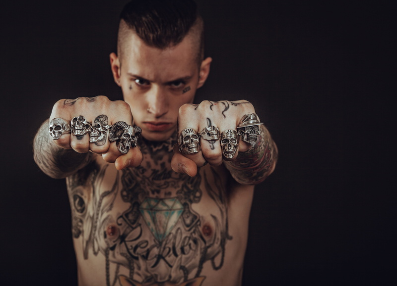 young, portrait, skin, young adult, dark, tattoo, one person, muscular build, rings, human, beautiful, studio, person, fashion, indoors, jewelry, skulls