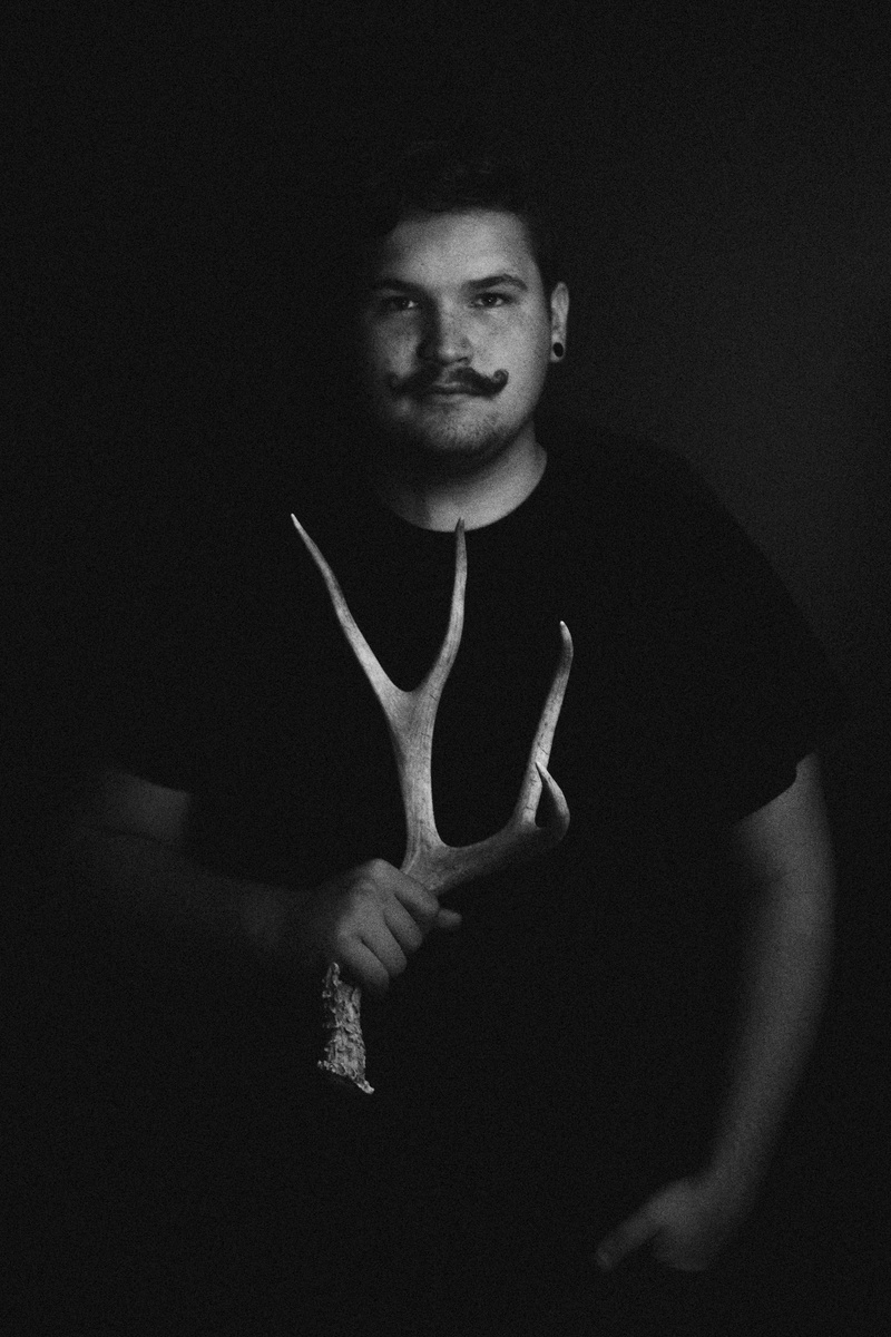 black background, real people, 5K, front view, men, young men, indoors, hand, one person, fierce, gesturing, fashion, hipster, model, bold, leisure activity