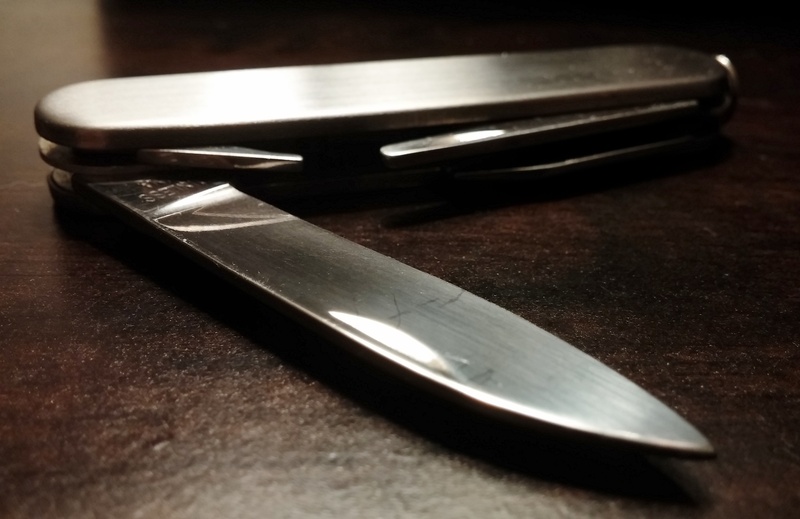 close-up, indoors, eating utensil, weapon, folding, steel, still life, single object, stainless, no people, multitool, household equipment, alloy, crime