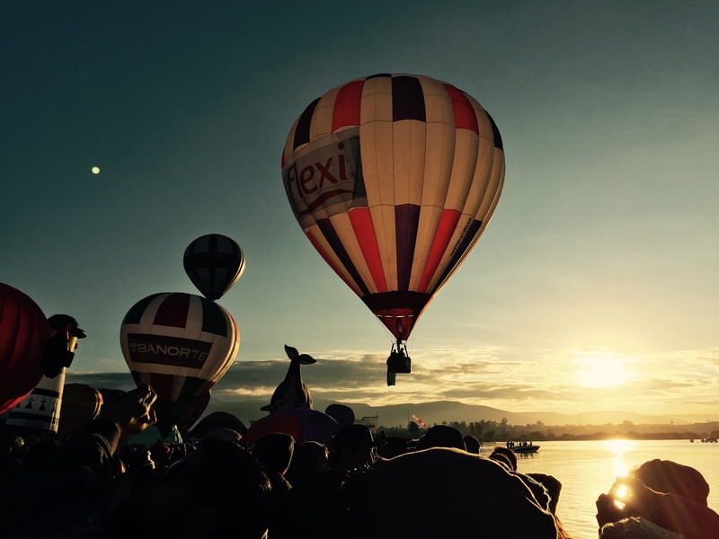 aerostatic, large group of people, mid-air, ballooning festival, flying, sky, real people, sunset, crowd, outdoors, mode of transportation, nature, leisure activity