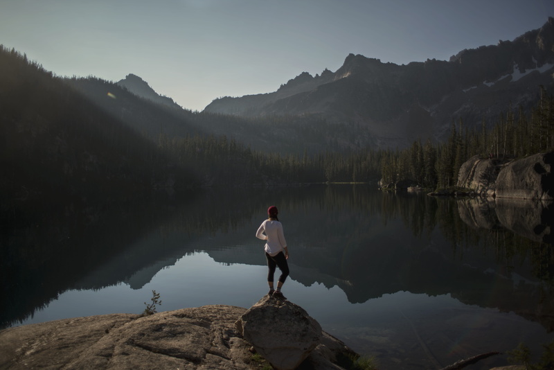 lake, full length, saddleback, mountain, water, beauty in nature, wilderness, tranquil scene, rock - object, light, tranquility, one person, tree, morning