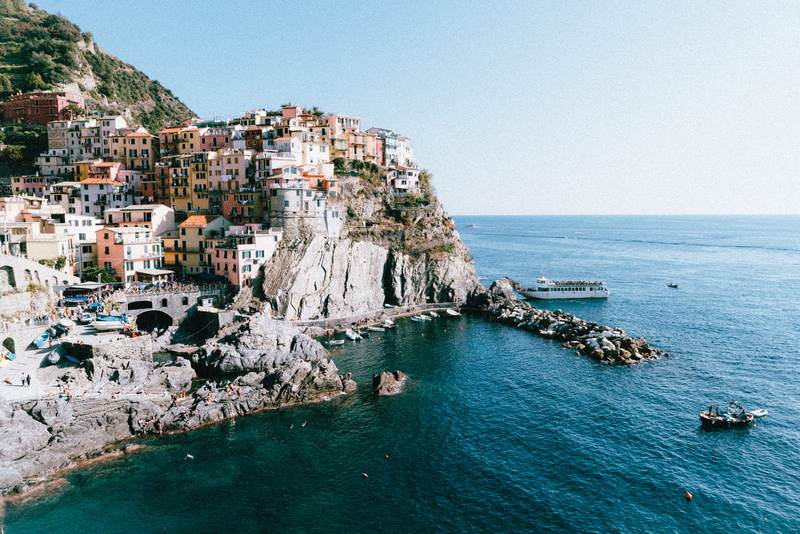town, city, cliff, outdoors, solid, concrete, clear sky, nature, horizon over water, coastline, water, coast, building exterior, beside, sky, commercial