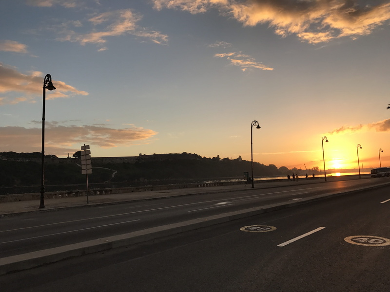 car, symbol, Street, street lamp, Malecon, sky, marking, road marking, land vehicle, motor vehicle, transportation, road, lighting equipment, mode of transportation