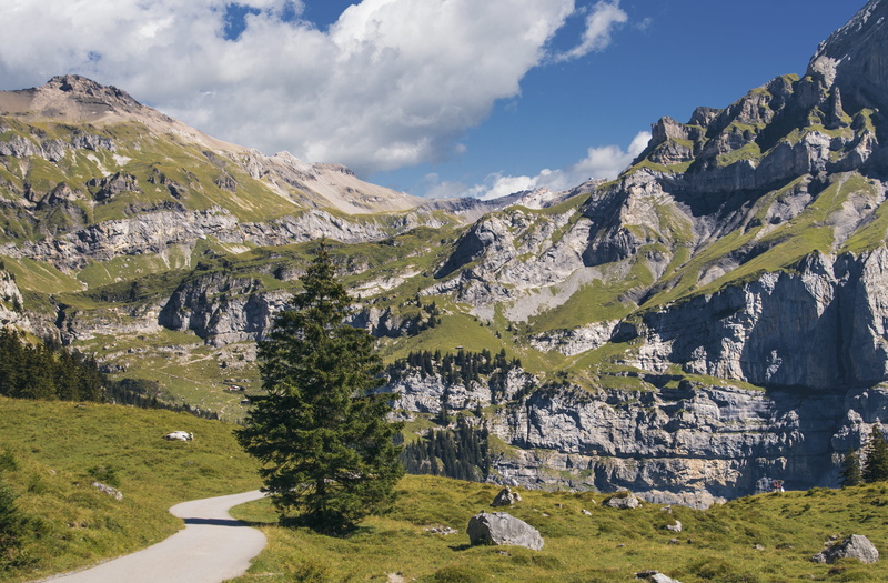 cloud - sky, mountain hiking, mountain range, beauty in nature, tranquility, non-urban scene, green color, day, outlook, no people, nature, trail, snowcapped mountain