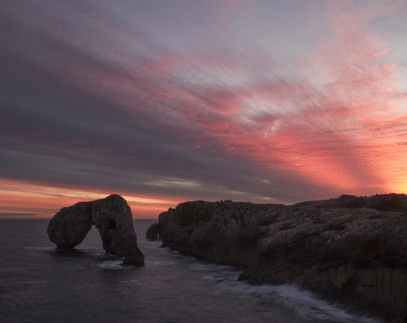 shoreline, beauty in nature, tranquil scene, no people, orange color, rock - object, sunrise. castro de las gaviotas, solid, rock formation, water, idyllic