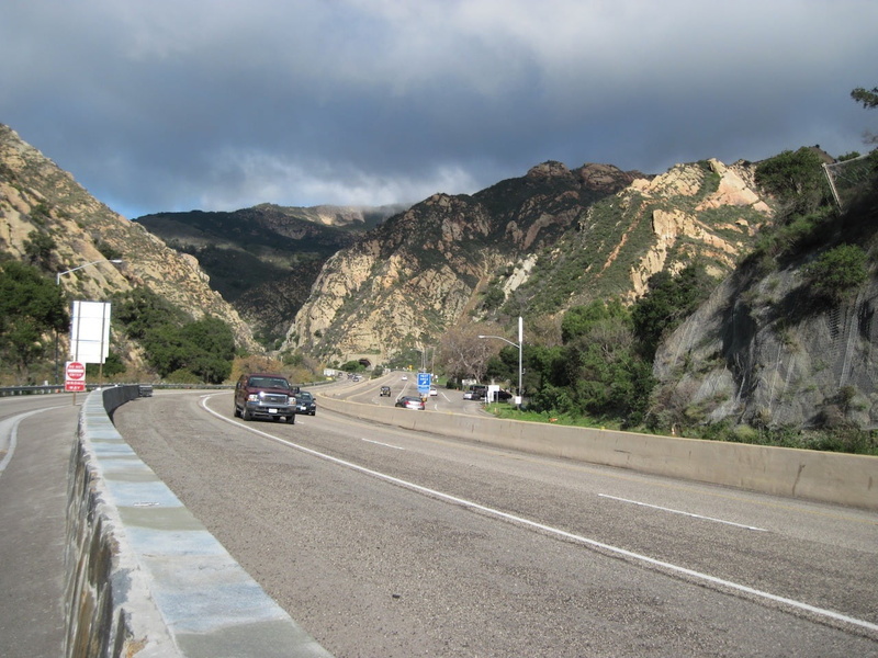 day, outdoors, landscape, cloud - sky, cars, highway, tunnel, transportation, road, gray, land vehicle, motor vehicle, sign, mountain, road trip, gaviota pass