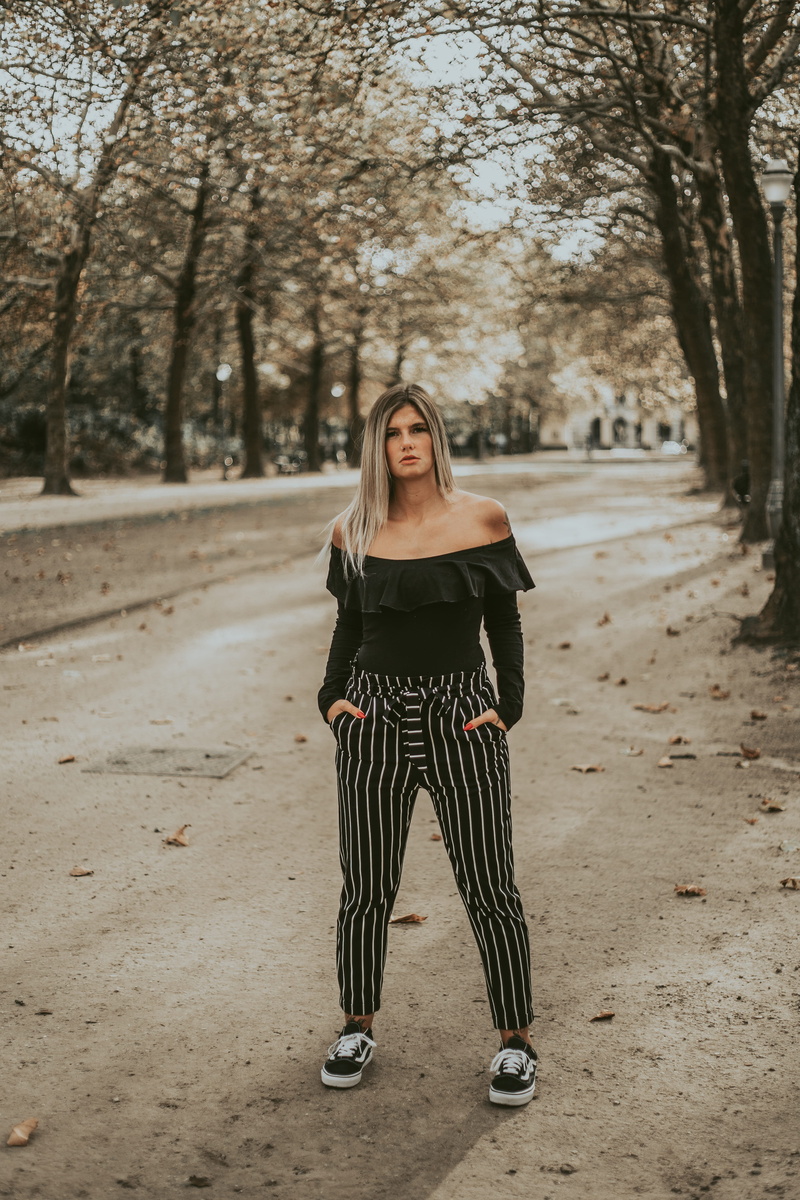 human, portrait, plant, shoulder, long sleeve, outdoors, expression, leisure activity, trees, looking at camera, serious, footwear, lady, young women, real people