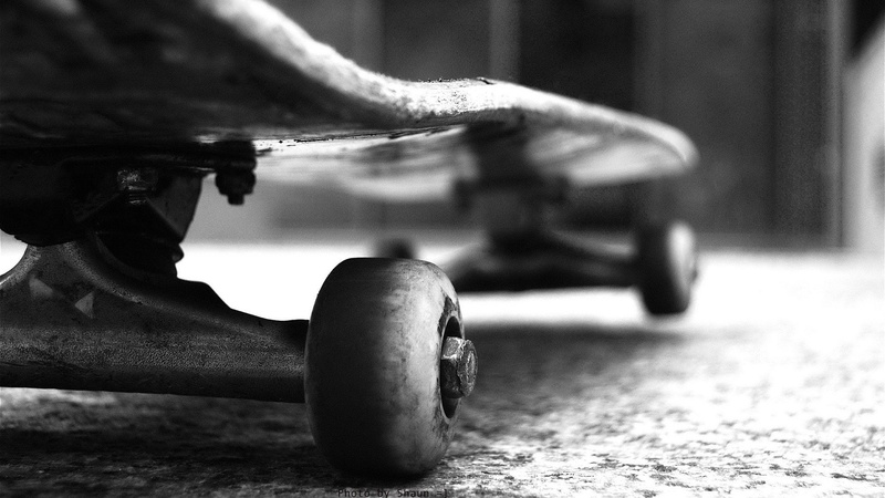 surface level, monochrome, city, wheelchair, hd, sports equipment, land vehicle, transportation, art, 1080P, skates, outdoors, focus on foreground, day