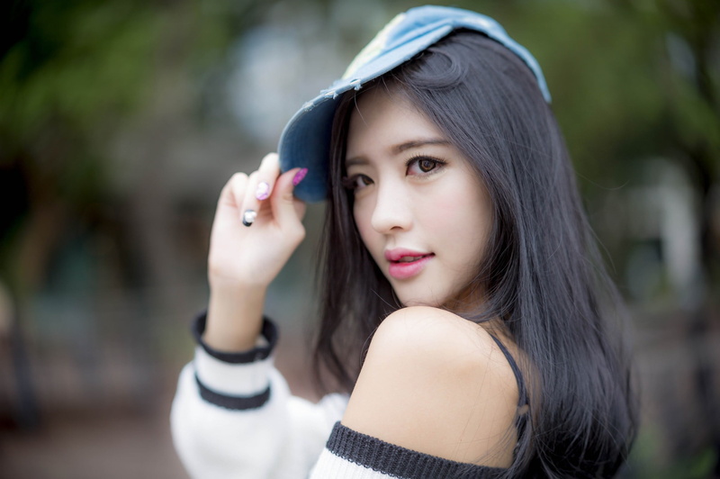 long hair, looking at camera, focus on foreground, adult, women, dark hair, headshot, beautiful woman, fake iris, hairstyle, day, lifestyles, women with hats