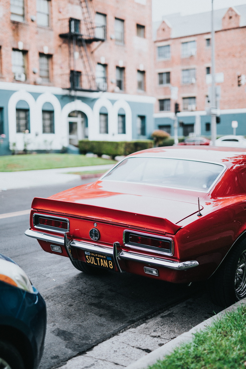 nature, building, building exterior, architecture, day, all red everything, transportation, car, motor vehicle, american made, road, outdoors, focus on foreground