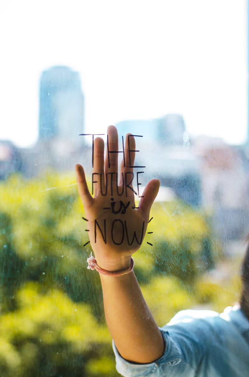 focus on foreground, human finger, landscape, real people, typo, lettering, human body part, communication, western script, day, glass - material, leisure activity