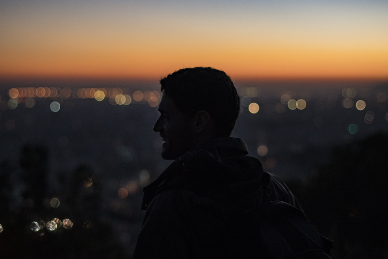 silhouette, person, headshot, adult, nighttime, cityscape, man, dusk, water, beauty in nature, right, lifestyles, orange color, high, leisure activity