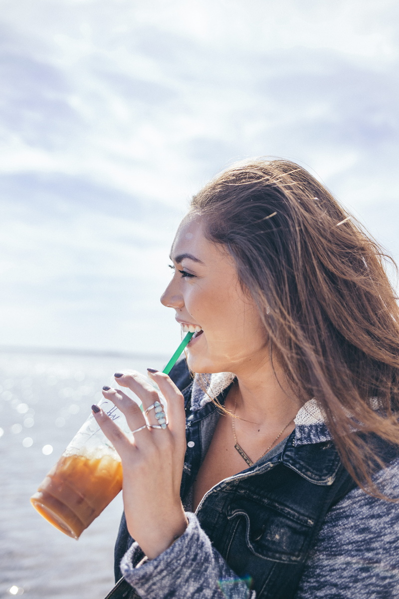 mouth, cup, food and drink, drink, one person, glass, lady, day, bottle, smile, water, iced coffee, holding, hairstyle, outdoors, 5K, cold coffee, young adult