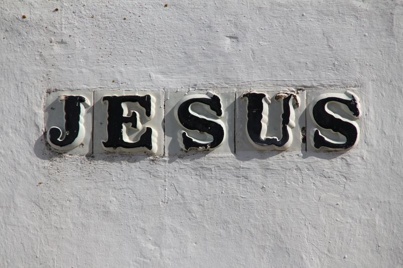 information sign, single word, close up, communication, capital letter, sign, close-up, jesus, nameplate, textured, ceramic wall, western script, built structure
