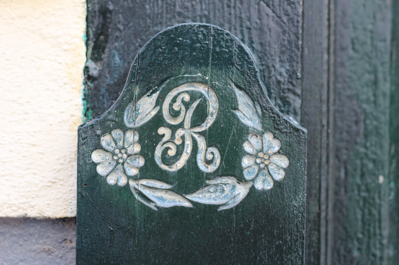 carving - craft product, initials, day, r, ownership, me, old, letter, right, human representation, architecture, metal, art and craft, outdoors, doorplate