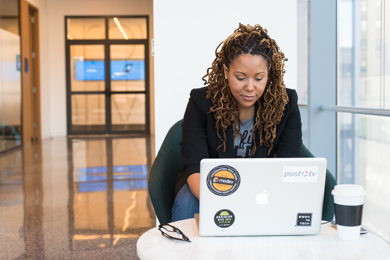 one person, wear, laptop, chair, furniture, development, work, front view, curly hair, technology, adult, office, working, lifestyles, young women, using