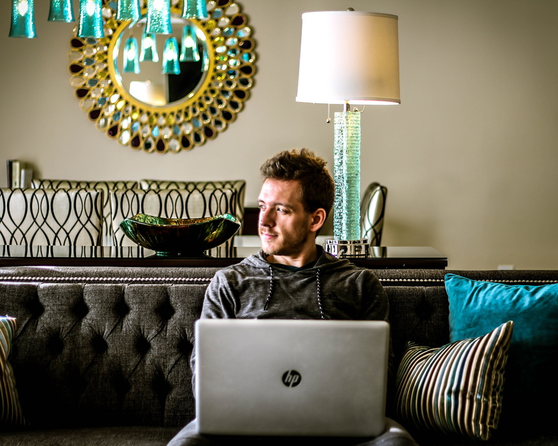illuminated, hp, wireless technology, laptop, mirror, man, using laptop, one person, connection, furniture, real people, silver, sitting, front view, reflection