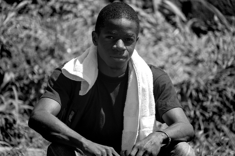young adult, casual clothing, teenager, 5K, african, young men, hairstyle, field, land, nature, lifestyles, smiling, looking at camera, black and white