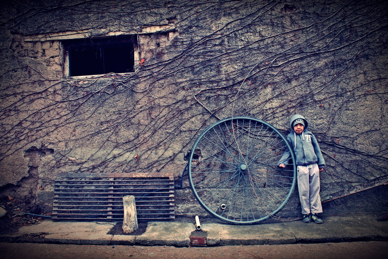 child, spoke, wall, real people, outdoors, leaned, transportation, wheel, full length, damaged, 4K, day, architecture, wall - building feature, hoodie