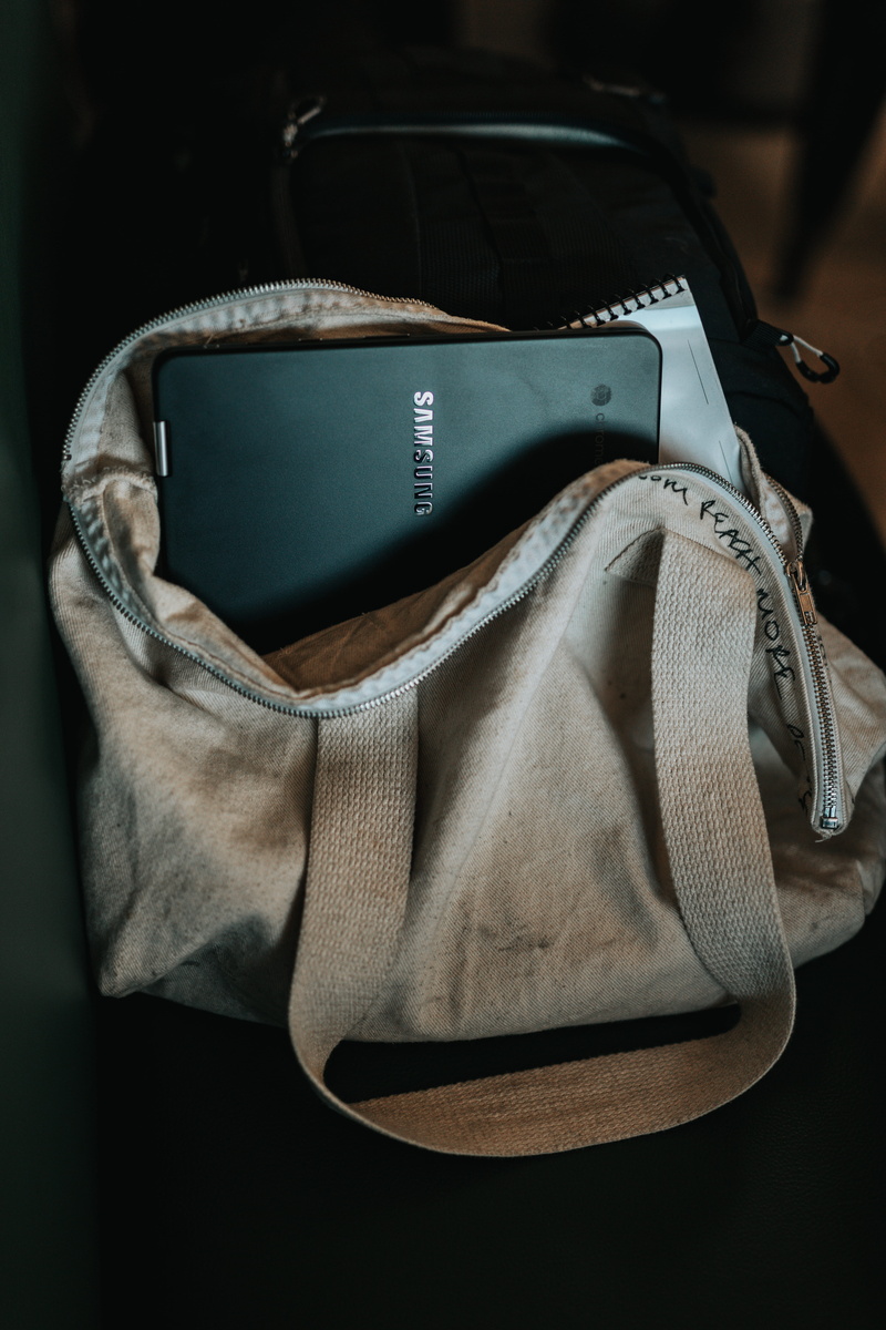 clothing, no people, bag, black, laptop, glasses, fabric, connection, shoe, indoors, tote, fashion, textile, sunglasses, computer, focus on foreground
