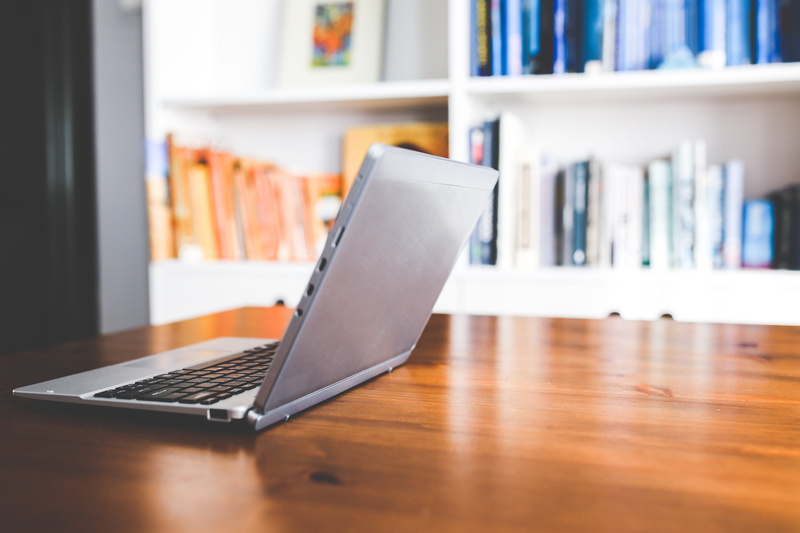 wireless technology, focus on foreground, table, netbook, work, working space, brown, wooden, black, wood - material, book, furniture, laptop, day, opened